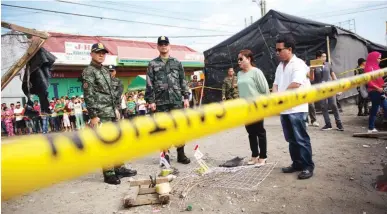  ??  ?? ON THE GROUND – Philippine National Police chief Director General Oscar Albayalde (left) inspects the blast site in Isulan, Sultan Kudarat yesterday. The Tuesday night explosion killed at least two individual­s and injured more than 30 others. (Amiel Cagayan)