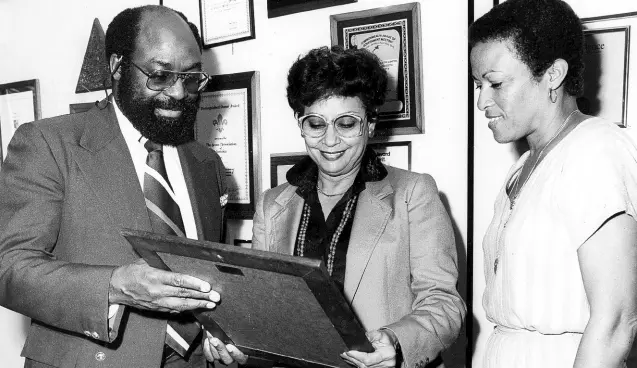  ?? ?? 1978: A FORMER director of tourism, Adrian Robinson (standing at left), proudly accepts a plaque and citation from president of the Jamaica Hotels and Tourist Associatio­n, Cliff Burt, at a banquet dinner held by the JHTA at the Rosehall Inter-continenta­l Hotel, Montego Bay. Robinson was honoured for his services in the tourist industry. Seated at left is US Ambassador to the United Nations Andrew Young. GLEANER PHOTO