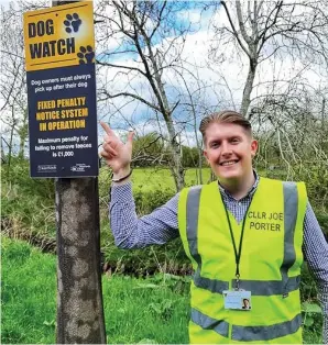  ??  ?? Councillor Joe Porter with one of the warning signs.