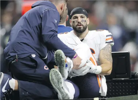  ?? CHRIS GRAYTHEN/GETTY IMAGES ?? Chicago Bears tight end Zach Miller is carted off the field after sustaining a severe knee injury Sunday against the New Orleans Saints. Miller’s popliteal artery was severed in the process and his return to the NFL is “virtually impossible,” says...