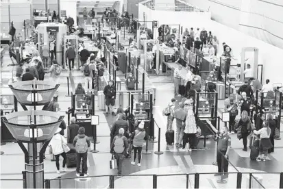  ?? PATRICK T. FALLON/GETTY-AFP ?? Passengers seen Tuesday at Denver Internatio­nal Airport, one day after a travel mask mandate was lifted.