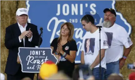  ?? GERALD HERBERT — THE ASSOCIATED PRESS ?? Republican presidenti­al candidate Donald Trump shares the stage with the family of Sarah Root at Joni’s Roast and Ride at the Iowa State Fairground­s, in Des Moines, Iowa, Saturday. Second from the left is Sarah’s mother, Michelle Root, brother Scott...