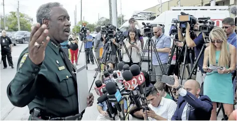  ?? JOHN RAOUX/THE ASSOCIATED PRESS ?? Orange County Sheriff Jerry Demings, left, answers questions at a news conference near the scene of a shooting where there were multiple fatalities in an industrial area near Orlando, Fla., Monday.