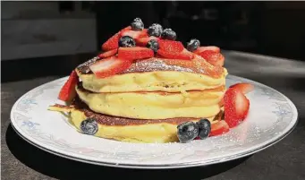  ?? Photos by Mike Sutter/Staff ?? Comfort Cafe served up a healthy stack of extra-fluffy pancakes topped with fresh berries.
Mr. Juicy’s chicken-fried steak was tender enough to eat with plastic utensils and featured an au poivre sauce made with shallots, peppercorn, cream and bacon.