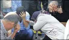  ?? ASSOCIATED PRESS ?? Relatives of people wounded at the explosions in Ankara, Turkey, wait for news about their loved ones outside a hospital on Saturday.