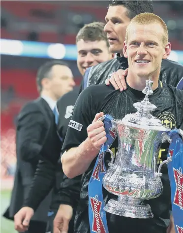  ??  ?? Callum McManaman (right) celebrates with Wigan Athletic’s FA Cup winning goalscorer Ben Watson back in May