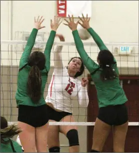  ?? MIKE BUSH/NEWS-SENTINEL ?? Above: Lodi 's Grace Diaz (12) sends the volleyball past two St. Mary's players in a TCAL match at The Inferno on Wednesday. Below: Lodi libero Katie Petersen sets up the volleyball for teammates Madison Steele (14), Grace Diaz (12) and Riley Woznick (8).