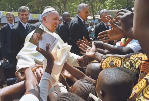  ?? GIUSEPPE CACACE, AFP/GETTY IMAGES ?? Pope Francis meets with children at a refugee camp in Bangui on Sunday. The pontiff arrived as “a pilgrim of peace” in conflict-ridden Central African Republic after visiting Uganda and Kenya.