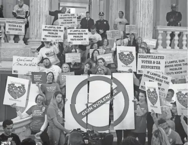  ?? KRIS CRAIG/THE PROVIDENCE JOURNAL, FILE ?? Supporters and opponents of gun-control legislatio­n crowd the State House rotunda in February 2020.