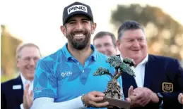  ?? — AFP photo ?? Pavon celebrates with the trophy after winning the Farmers Insurance Open at Torrey Pines South Course in La Jolla, California.