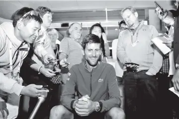  ?? - AFP photo ?? Novak Djokovic answers questions Wednesday ahead of the start of the ATP Miami Open.