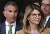  ?? STEVEN SENNE — THE ASSOCIATED PRESS ?? Mossimo Giannulli, left, and his wife, Lori Loughlin, are charged in the college admissions scandal.