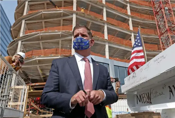  ?? MATT sToNE / hErAld sTAFF FIlE ?? GET ORGANIZED: Mayor Martin Walsh, seen signing the last beam during the topping off of MassMutual’s headquarte­rs in the Seaport and, below, speaking during the Greater Boston Labor Council’s Labor Day event, would have plenty of support from unions if he’s picked for labor secretary.