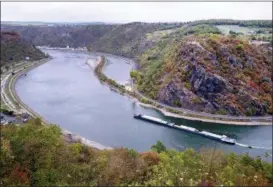  ?? MICHAEL PROBST — THE ASSOCIATED PRESS ?? A cargo ship passes Oct. 24 the Loreley rock at the river Rhine in St.Goar, Germany, during historical­ly low water levels.