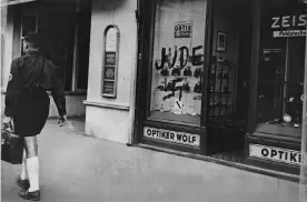  ??  ?? A Jewish-owned optician’s shop in Austria marked by the Nazis with the word ‘Jew’ and a swastika. Photograph: Hulton Deutsch/Corbis/Getty Images