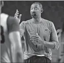  ?? CARLOS OSORIO/AP ?? Michigan coach Juwan Howard works with his Wolverines at practice.