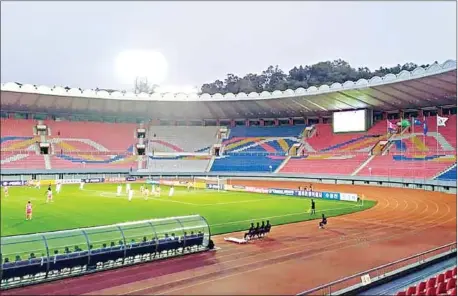  ?? HANDOUT/KOREA FOOTBALL ASSOCIATIO­N/AFP ?? South Korea (in white) and North Korea play in front of empty stands during the World Cup 2022 Asian zone Group H qualifyier at Kim Il Sung Stadium in Pyongyang in a match almost completely blocked off from the outside world.