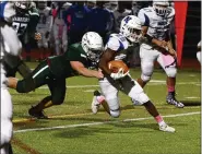  ?? OWEN MCCUE - MEDIANEWS GROUP ?? Norristown’s Zion Malone, right, is tackled from behind by Methacton’s Dan Meier.