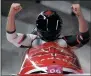  ?? AP PHOTO/MICHAEL SOHN ?? Driver Justin Kripps and Alexander Kopacz of Canada celebrate as they cross the finish area after tying for the gold with Germany during the twoman bobsled final Monday.