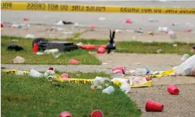  ?? Photograph: Julio Cortez/AP ?? Party debris strewn in the area of a shooting in Baltimore Sunday.