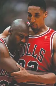  ?? The Associated Press ?? STAYING POWER: Chicago Bulls Scottie Pippen, right, embraces an exhausted Michael Jordan following their win in Game 5 of the Aug. 11, 1997, NBA Finals against the Utah Jazz in Salt Lake City. The flu-like illness Jordan fought through to lead the Bulls to a crucial victory in the 1997 NBA Finals created instant fodder for the virtue of perseveran­ce. Pushing past boundaries, overcoming obstacles and adversity — that is part of the ethos of major competitiv­e sports. That is how elite athletes become wired to win.