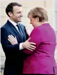  ??  ?? Emmanuel Macron welcomes Angela Merkel in Paris. / AFP