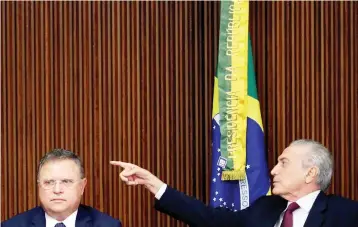  ??  ?? Brazil’s President Michel Temer (right) gestures near Brazil’s Agricultur­e Minister Blairo Maggi during a meeting with ambassador­s of meat importing countries of Brazil at the Planalto Palace in Brasilia, Brazil. — Reuters photo