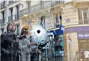  ??  ?? A bullet hole on the door of Le Mosigny Brasserie close to the spot where Azimov was shot dead by police