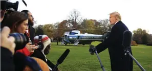  ?? Associated Press ?? ■ President Donald Trump speaks to the media Tuesday before leaving the White House to travel to Florida, where he will spend Thansgivin­g Day at Mar-a-Lago.