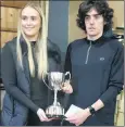  ?? ?? Overall race winner Declan Moore of Bilboa AC being presented with the Michael Curley Cunningham 4-Mile Memorial Cup by Curley’s niece Molly, last Friday night.