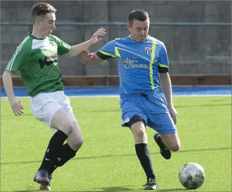  ?? Photo by Domnick Walsh ?? Johnny McCarthy, Strand Road FC, clears the ball as Mike Hutson, Ballyheigu­e, tries to close him down during the Division 1A 3-3 draw in Mounthawk Park, Tralee last Sunday.