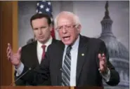  ?? J. SCOTT APPLEWHITE — THE ASSOCIATED PRESS ?? Sen. Bernie Sanders, I-Vt., joined at left by Sen. Chris Murphy, D-Conn., holds a news conference after the Senate passed a resolution he introduced that would pull assistance from the Saudi-led war in Yemen, a measure to rebuke Saudi Arabia after the killing of journalist Jamal Khashoggi, at the Capitol in Washington, Thursday.