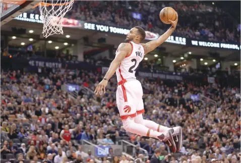  ?? — USA Today Sports ?? Toronto Raptors guard Norman Powell (24) goes up and dunks against the Los Angeles Lakers at Air Canada Centre. The Raptors beat the Lakers 113-80.