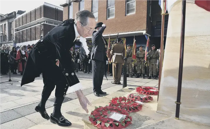 ??  ?? Neil McKittrick laying a wreath in Peterborou­gh on Remembranc­e Day