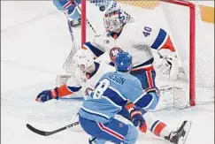  ?? Graham Hughes / Associated Press ?? Montreal’s Mike Matheson (8) scores the winning goal against New York Islanders goaltender Semyon Varlamov on Saturday.