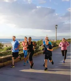  ??  ?? Employees from the Beach Cities Health District jog along the Manhattan Beach strand in Southern California as part of the district’s WorkWell to LiveWell program.