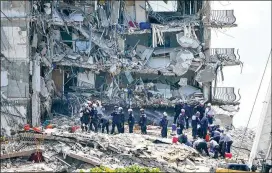  ?? LYNNE SLADKY/ASSOCIATED PRESS ?? Rescue workers search the rubble of the Champlain Towers South condominiu­m on Saturday in Surfside, Fla. Families frustrated with the slow pace of recovery efforts are said to have demanded they be allowed to go to the scene.