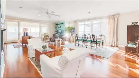  ?? Photos by REtoolz ?? Above: The living and dining room in the open floor plan at 91 Hillside Ave. in Milford features panoramic water views and Brazilian cherry floors. Below: A gourmet chef’s kitchen includes a granite-topped center island and sleek stainless steel...