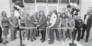  ?? PEDRO PORTAL pportal@miamiheral­d.com ?? Miami Commission­er Joe Carollo, center, is flanked by Jackson Health CEO Carlos Migoya, left, and Miami Fire Rescue Chief Joseph Zahralban during a ceremony with staffers at the Miami Firefighte­rs Health & Wellness Center on Thursday.