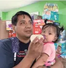  ?? ALAN GOMEZ / USA TODAY ?? Romeo Ramirez bottle feeds his 9-month-old daughter, Elizabeth. His wife, Norma, is in custody after an immigratio­n raid in Mississipp­i.
