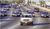  ?? LOS ANGELES TIMES ?? Police cruisers follow a white Ford Bronco driven by A.C. Cowlings on a Los Angeles freeway in 1994. O.J. Simpson was in the back of the vehicle, reportedly holding a gun to his own head.