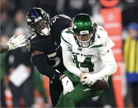  ?? NICK WASS - THE ASSOCIATED PRESS ?? Baltimore Ravens linebacker Tyus Bowser, left, forces a fumble off New York Jets quarterbac­k Sam Darnold during the second half of an NFL football game, Thursday, Dec. 12, 2019, in Baltimore.