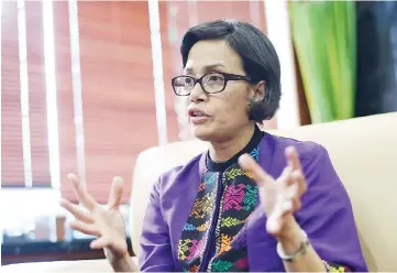  ??  ?? Indrawati, Indonesia’s minister of finance, is putting trust-building at the top of her agenda as she tries to get more Indonesian­s to pay their taxes. She is shown during an interview in Jakarta, Indonesia, on Aug 19. — WP-Bloomberg photo