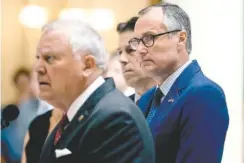  ?? ALYSSA POINTER/ATLANTA JOURNAL-CONSTITUTI­ON VIA AP ?? Georgia Lt. Gov. Casey Cagle, right, listens to Gov. Nathan Deal during a press conference at the state Capitol in Atlanta last week.