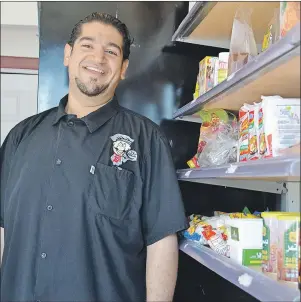  ?? NIKKI SULLIVAN/CAPE BRETON POST ?? Hussain Ftil, owner of Big Kahuna Sub and Middle Eastern Grocery, stands beside his shelf of products that he says can’t be found anywhere else in the CBRM. Ftil also says all his products and food are halal, which means it adheres to Islamic law, as...