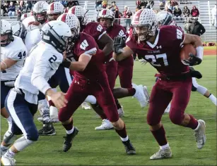  ?? Jackie L. Turner photos ?? Woonsocket’s Emmanuel Gomes (27) rushes for one of his three touchdowns Saturday.