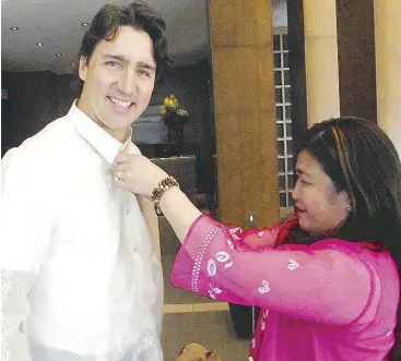  ?? Photo by PHILIP MENDOZA, Waves News ?? Barong image model: Teresa Torralba, publisher of Waves News in Canada, shows Justin Trudeau the proper way of wearing the barong tagalog, which cost $85 (about P3,400) at a Filipino store in Chinatown Toronto.