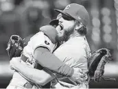  ?? Tony Dejak / Associated Press ?? The Reds’ Wade Miley is congratula­ted by catcher Tucker Barnhart after no-hitting the Indians.