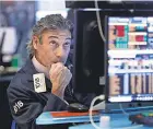  ?? RICHARD DREW/ AP ?? Trader John Romolo watches the market turmoil at the New York Stock Exchange.