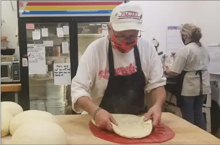  ?? PHOTOS BY JORDANA JOY — THE MORNING JOURNAL ?? Tim Kiedrowski, owner of Kiedrowski’s Simply Delicious Bakery at 2269Cooper Foster Park Road in Amherst, flattens out paczki dough Feb. 4 in preparatio­n for paczki season.